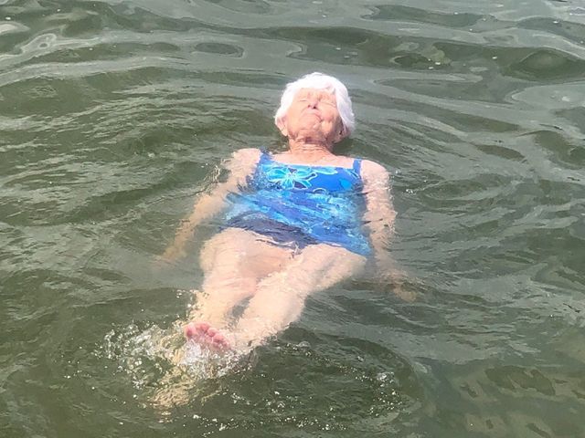 A woman is floating in a lake