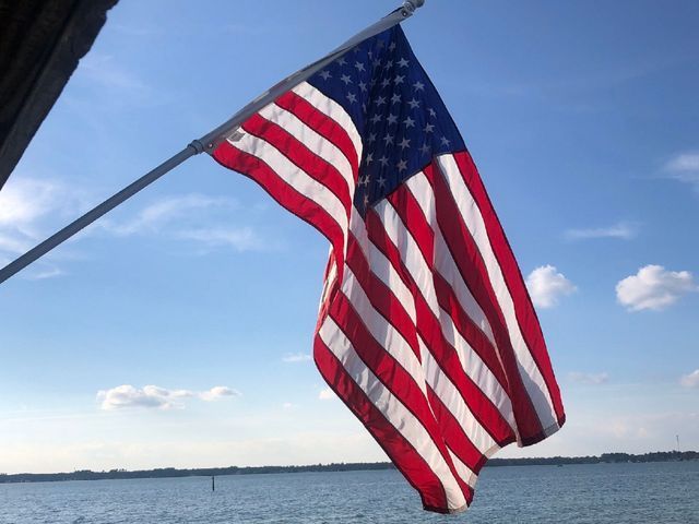 An american flag is flying over a body of water