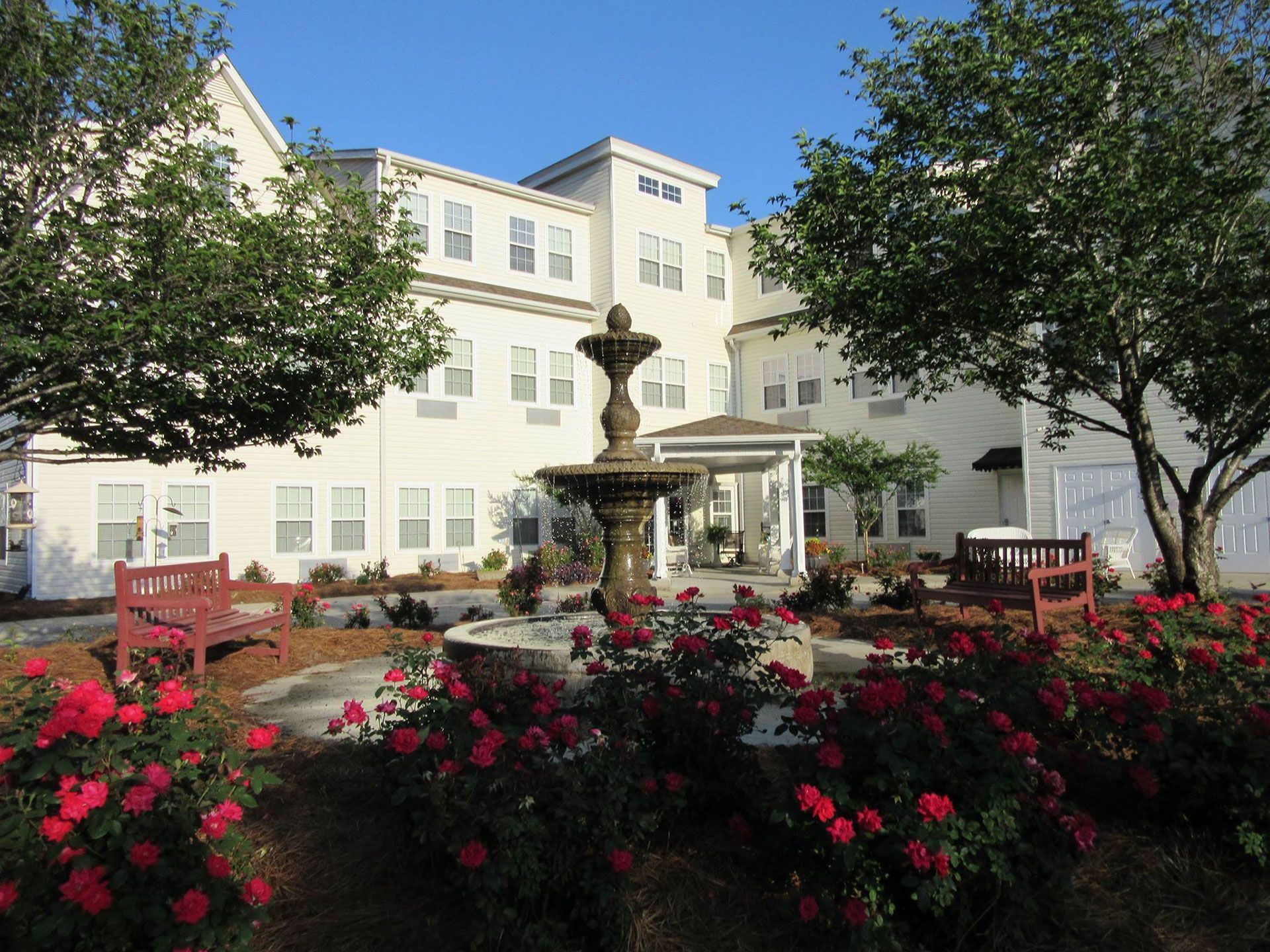 A large white building with a fountain in front of it
