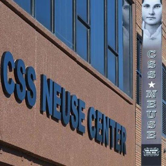 A sign for the css neuse center is on the side of a building