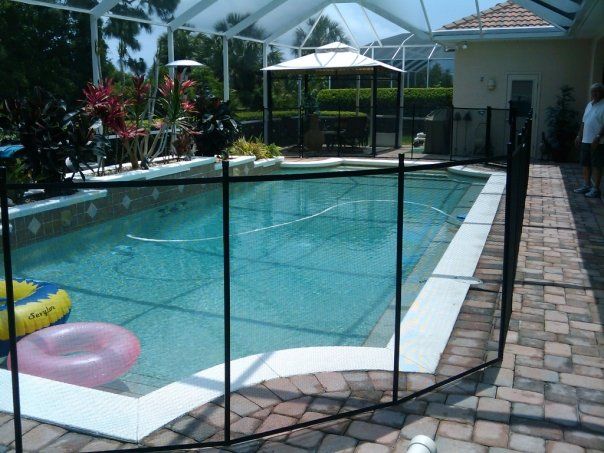 A large swimming pool with a fence around it