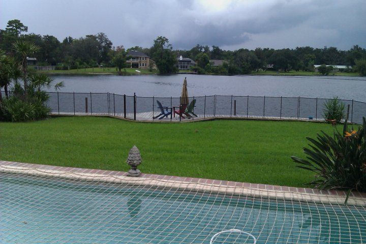 A view of a lake from a swimming pool