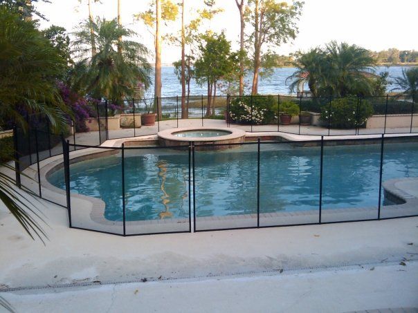 A large swimming pool with a fence around it