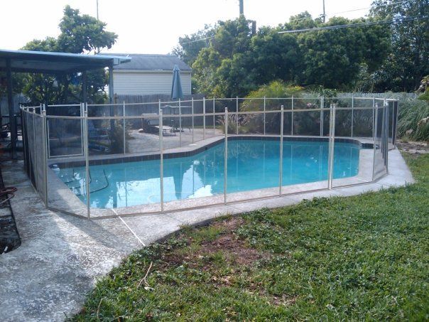 A large swimming pool with a fence around it