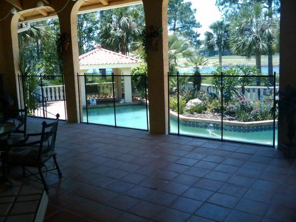 A patio with a pool and a gazebo in the background