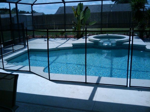 A large swimming pool with a fence around it