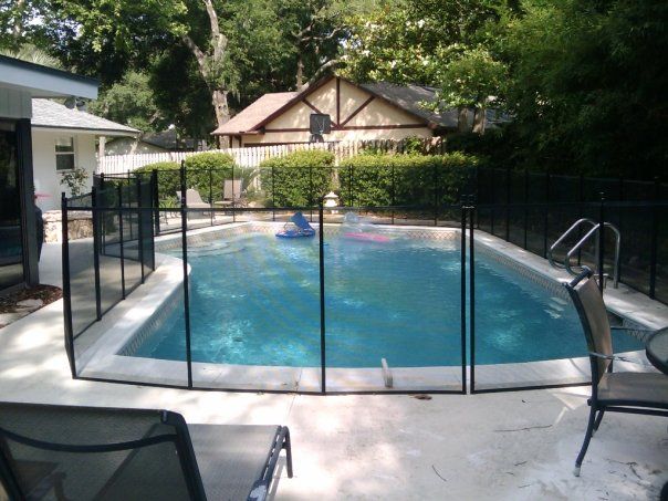 A large swimming pool with a fence around it