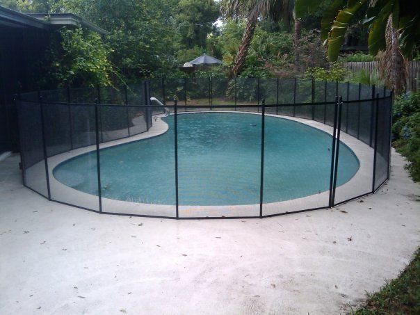 A large swimming pool with a fence around it