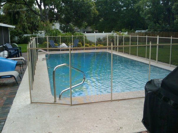 A large swimming pool with a fence around it