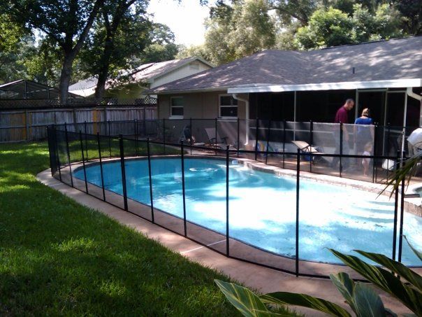 A large swimming pool with a fence around it