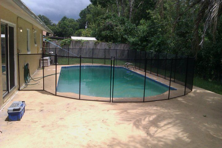 A large swimming pool with a fence around it.
