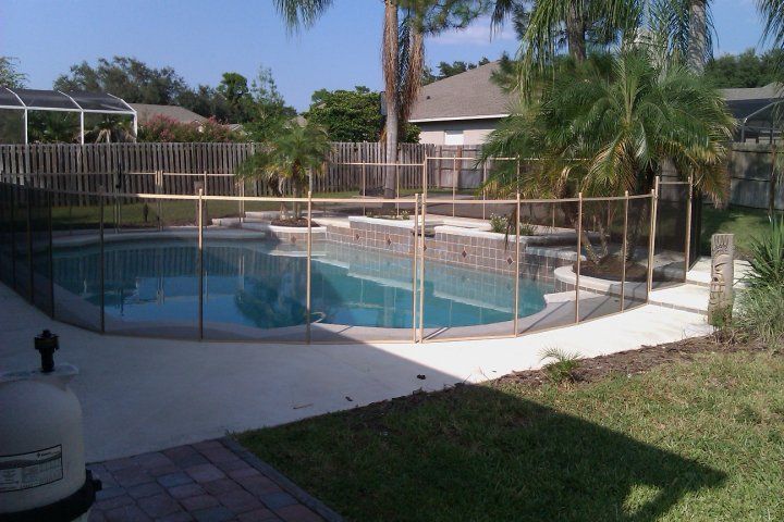 A large swimming pool with a fence around it