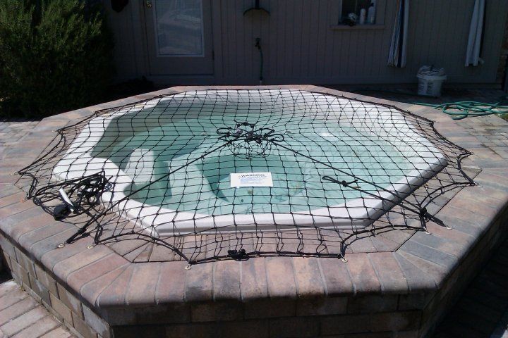 A hot tub with a spider web around it