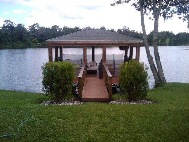A gazebo sits on the shore of a lake