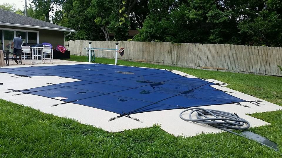 A swimming pool with a blue cover on it