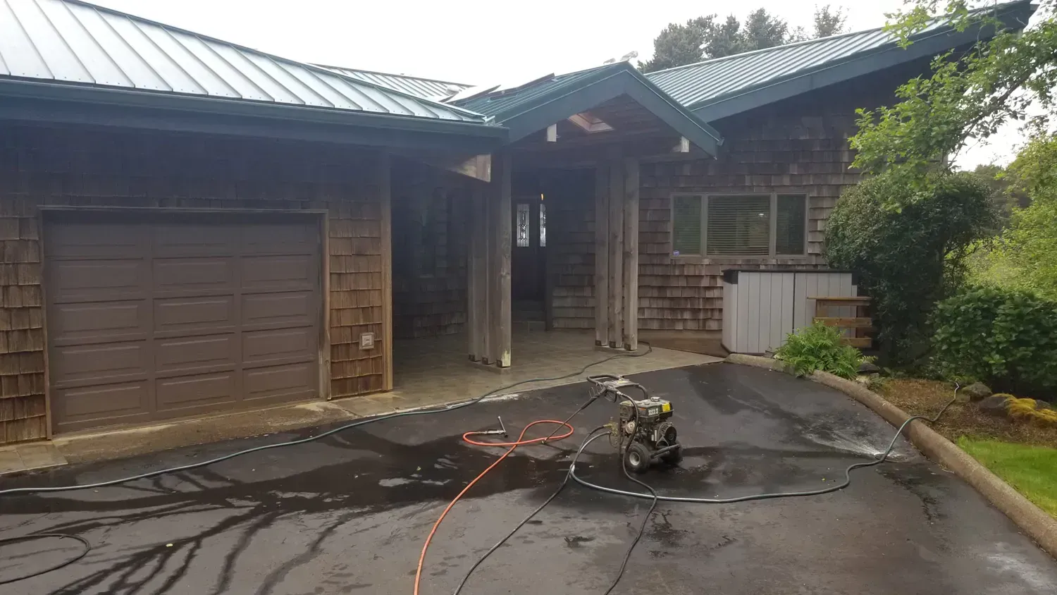 A house with a large driveway and a machine in front of it.