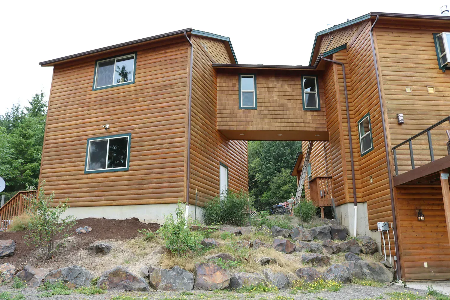 A large wooden house with stairs leading up to it