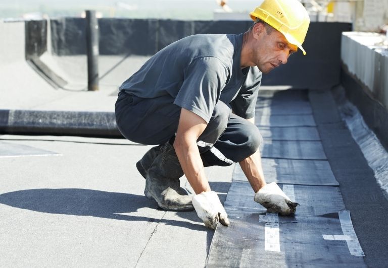 Flat, light-colored concrete rooftop with a dark border.