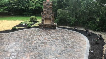 Finished stone patio and outdoor fireplace