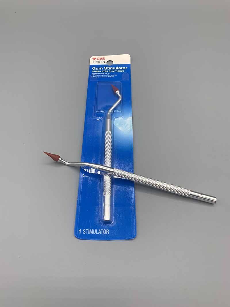 A pair of dental instruments in a blue package on a table.