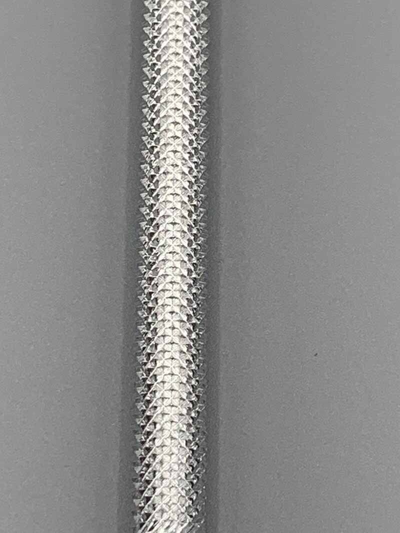 A close up of a white rope on a gray surface.
