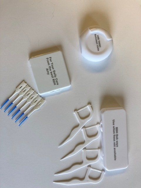 A set of dental floss picks sitting on a white surface