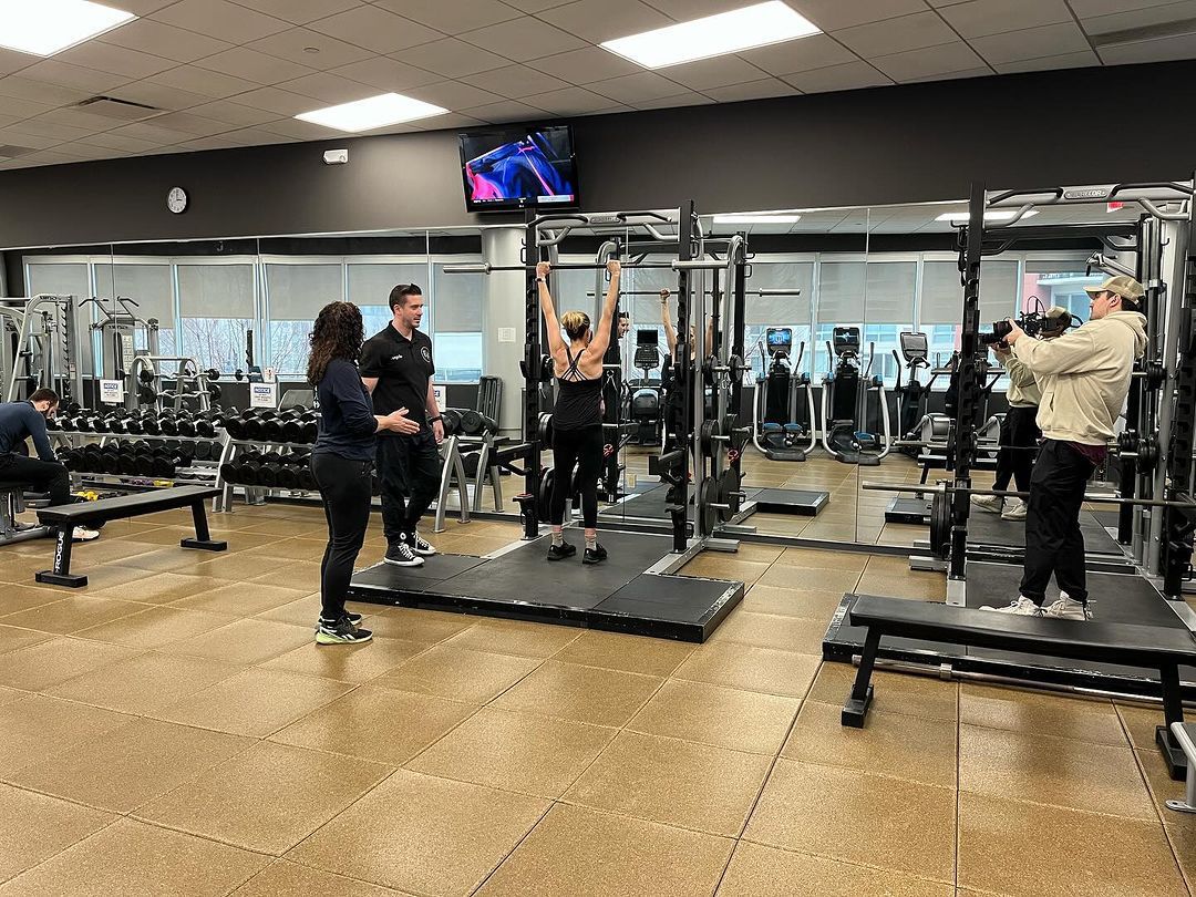 A group of people are working out in a gym.