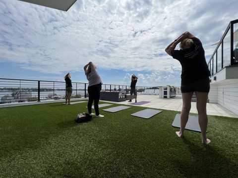 a group of people are doing yoga on a rooftop