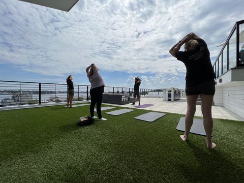 A group of people are doing yoga on a rooftop.