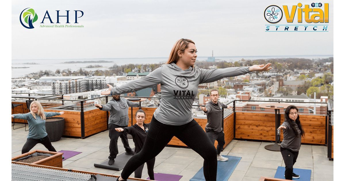 a group of people are doing yoga on a rooftop .