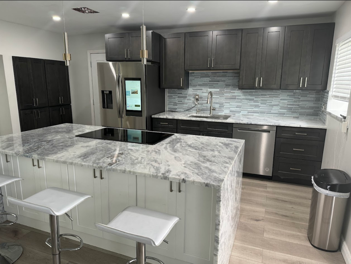 A kitchen with stainless steel appliances and granite counter tops.