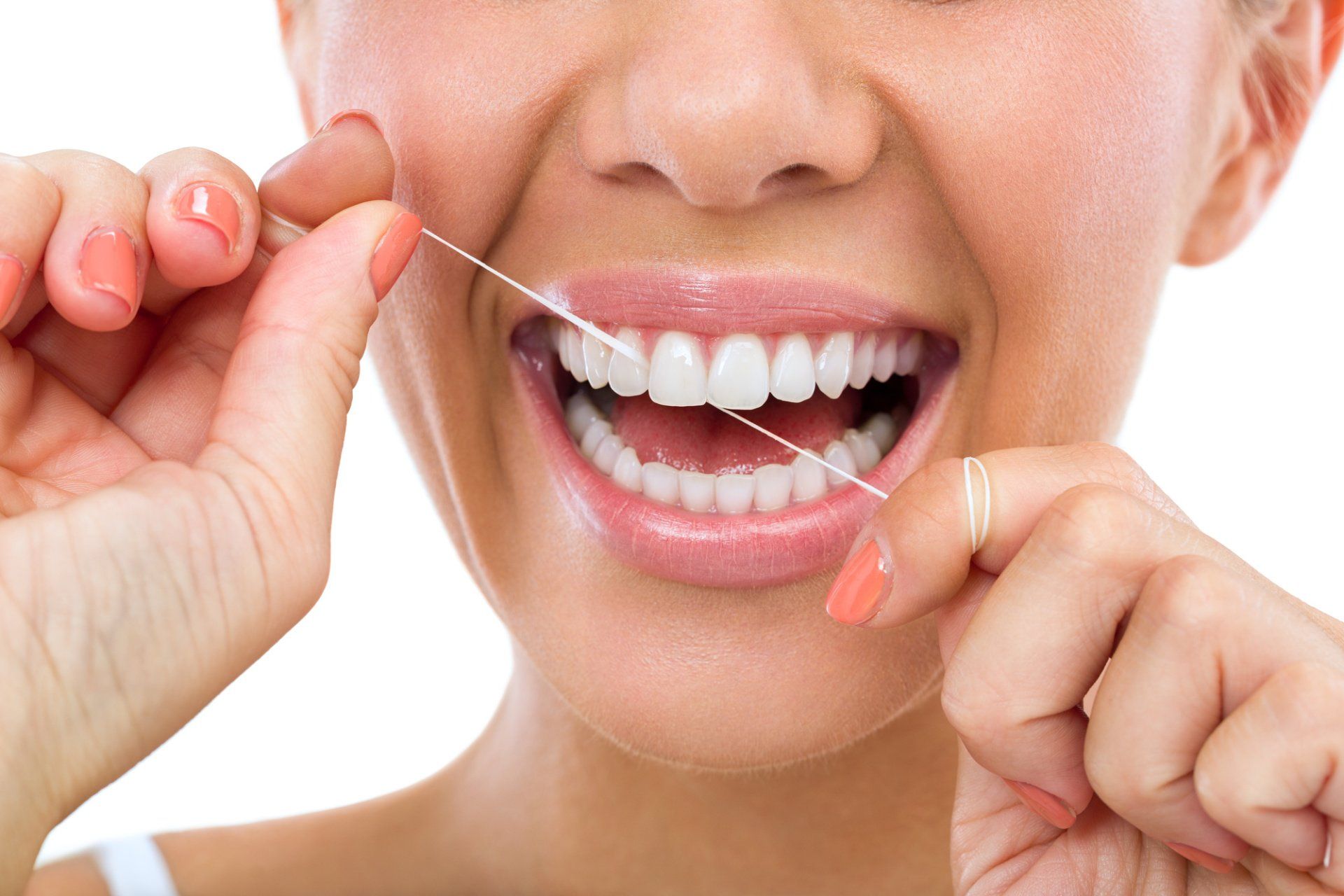 a woman is flossing her teeth with a dental floss