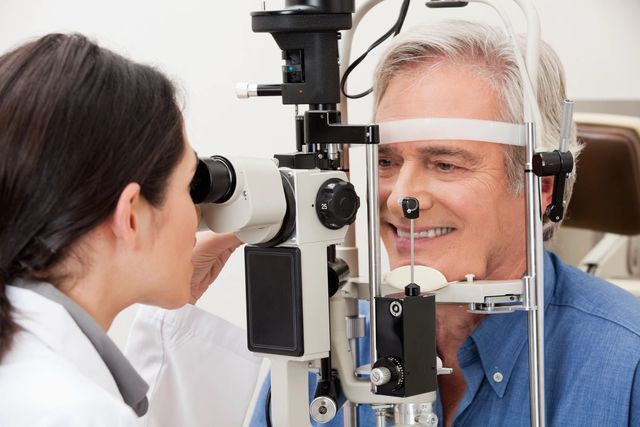A man is getting his eyes examined by an ophthalmologist