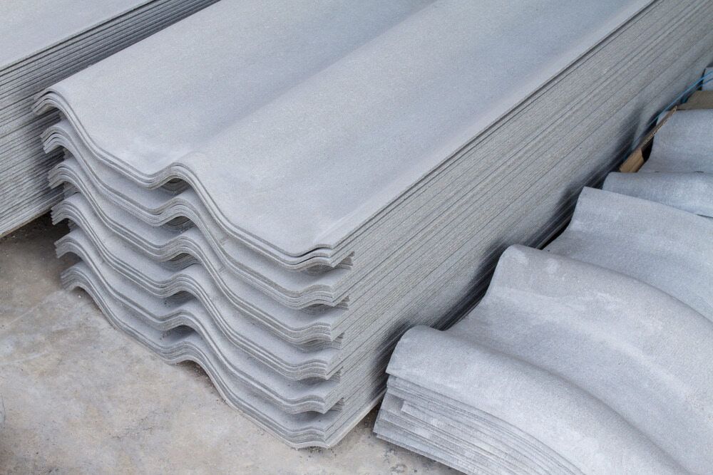 A Stack of Gray Corrugated Roofing Sheets on the Ground — Rooftop Northern Rivers In Ballina, NSW