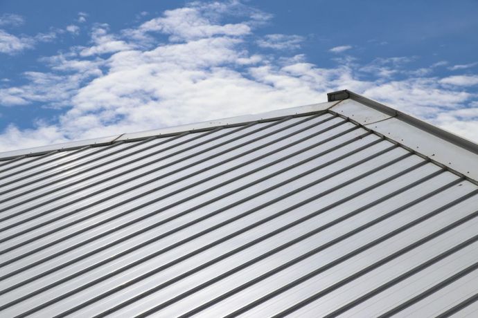 A Close Up of a Metal Roof With a Blue Sky in the Background