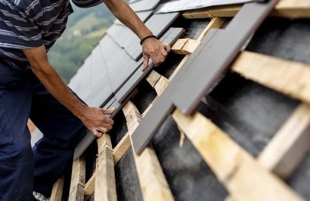 A Man Is Working on The Roof of A House — Rooftop Northern Rivers In Ballina, NSW