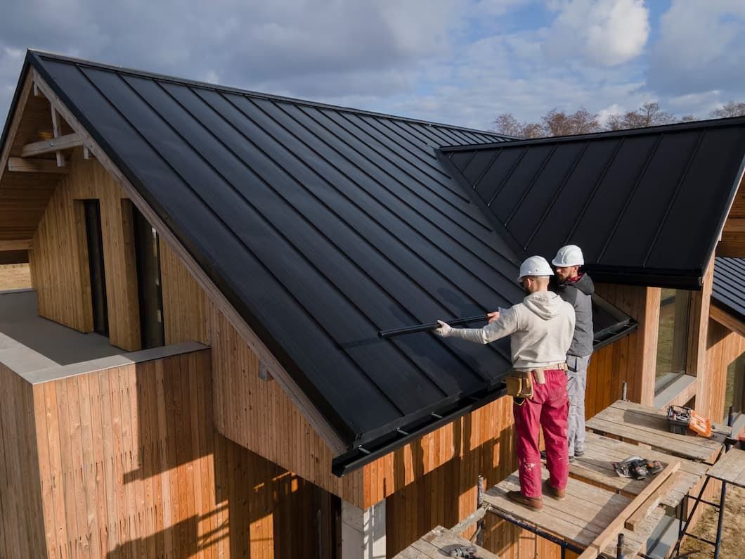 Two Men Are Working on The Roof of A House — Rooftop Northern Rivers In Lismore, NSW