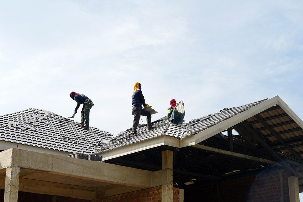 Two Men Are Working on the Roof of a Building — Rooftop Northern Rivers In Ballina, NSW
