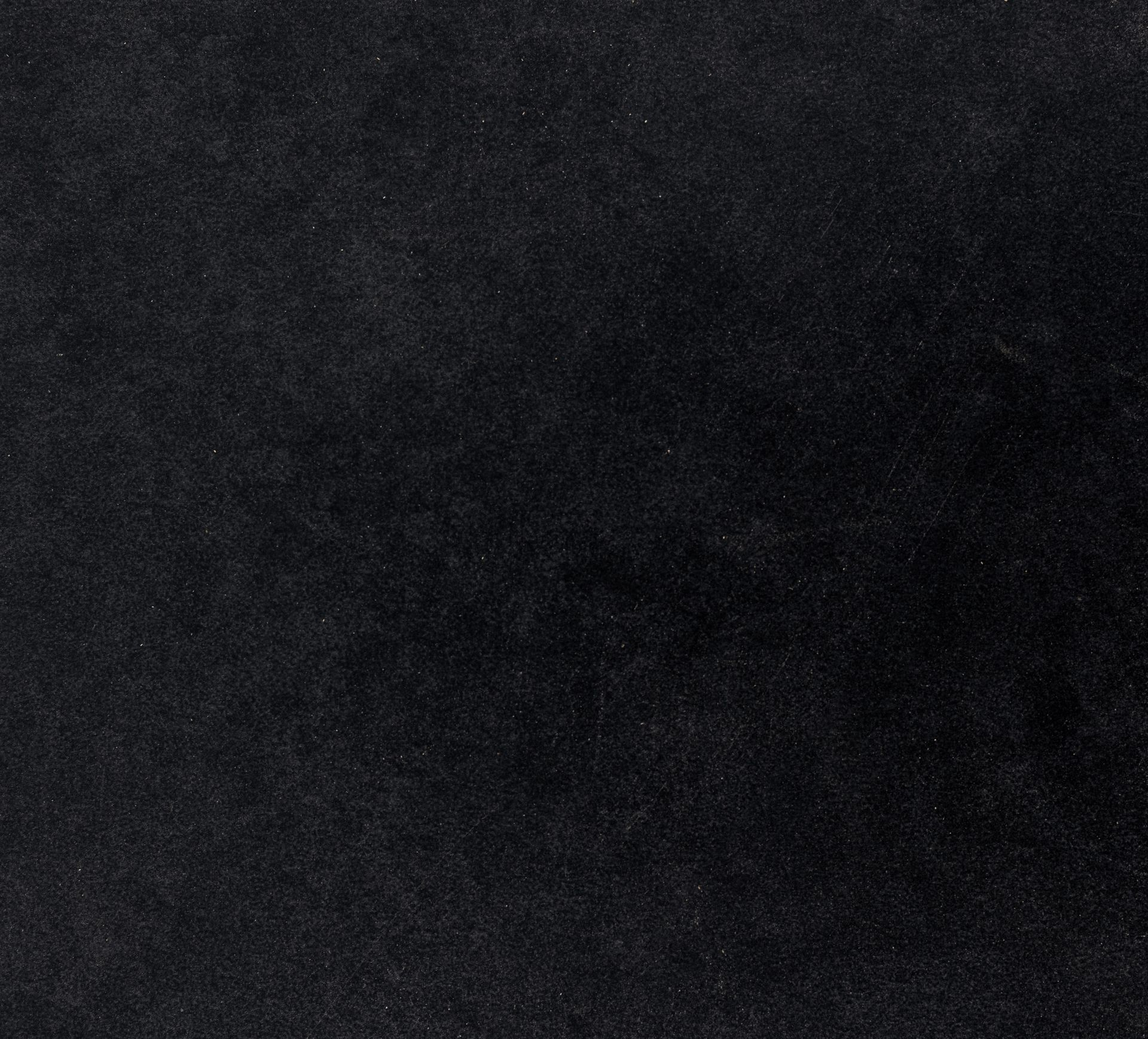 Solid black background with subtle speckling.