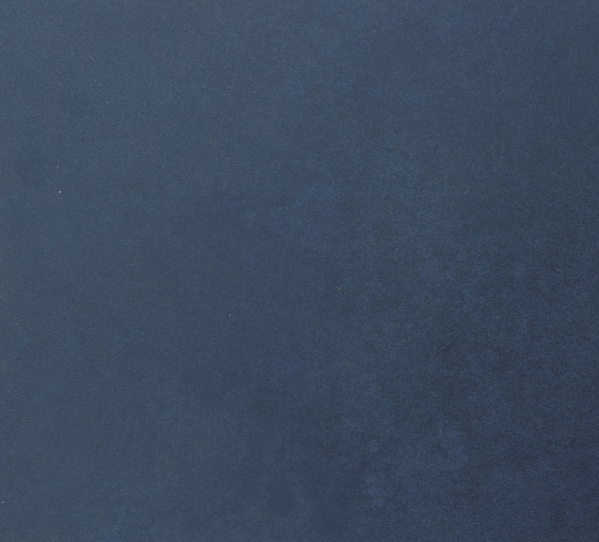 Solid blue velvet fabric texture.