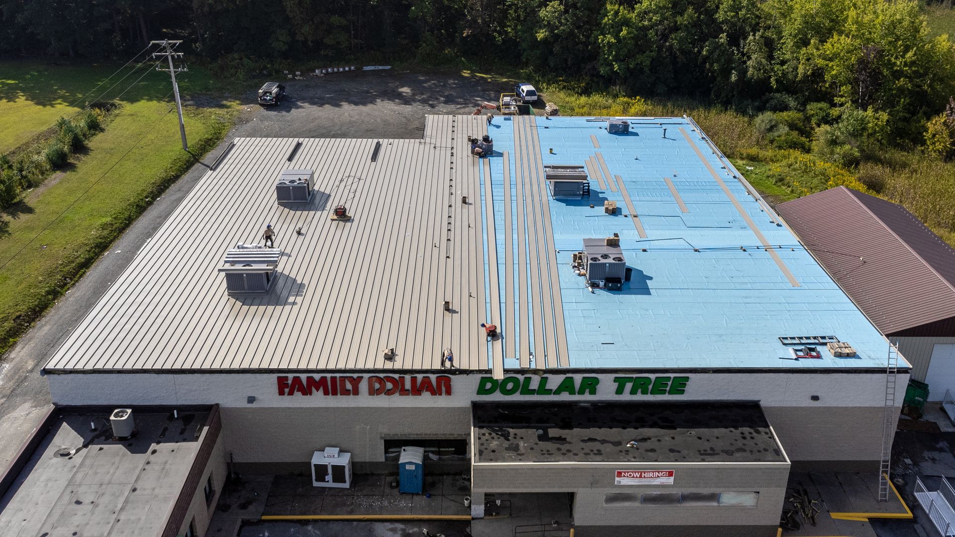 Aerial view of a Family Dollar and Dollar Tree store with a light blue and grey roof.