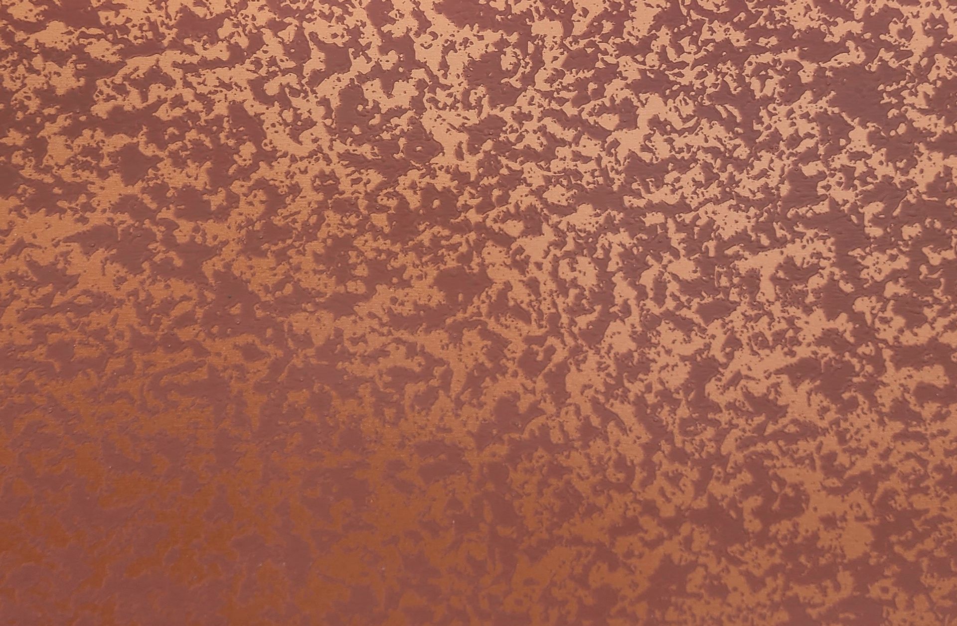 Textured copper-colored surface with a mottled, distressed pattern.