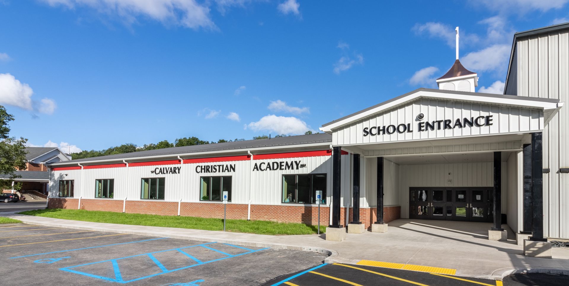 Exterior of Joan D. O'Brien Academy with school entrance on a sunny day.