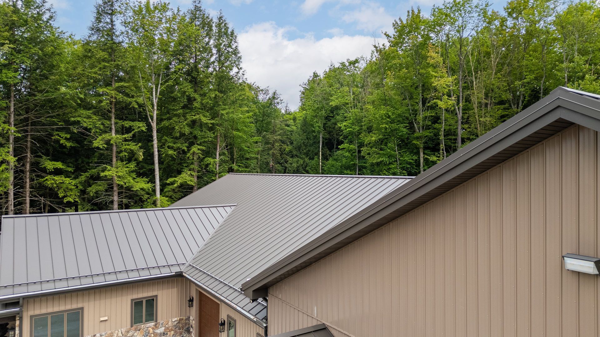 Side profile showing seamless metal roof design on custom garage, State College.
