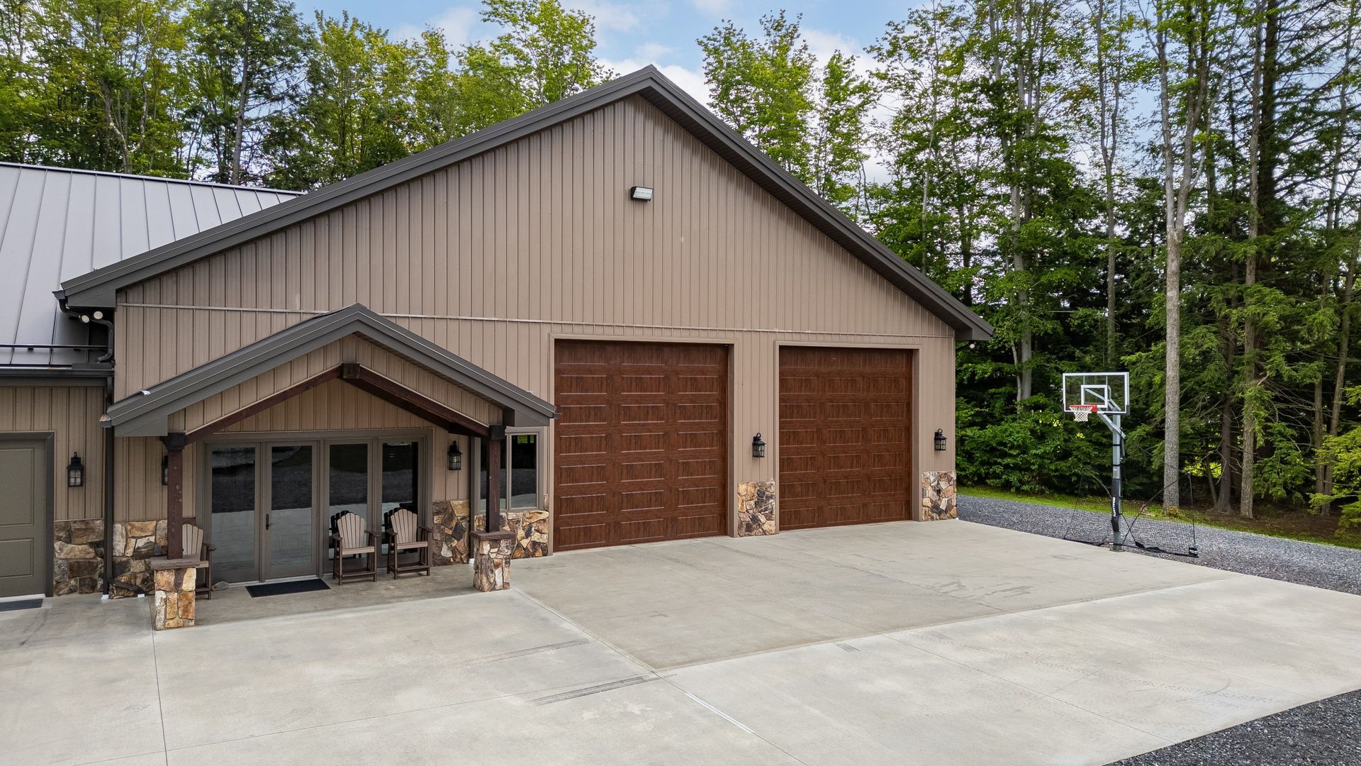 Front view of custom garage with brown doors and metal roof, State College.