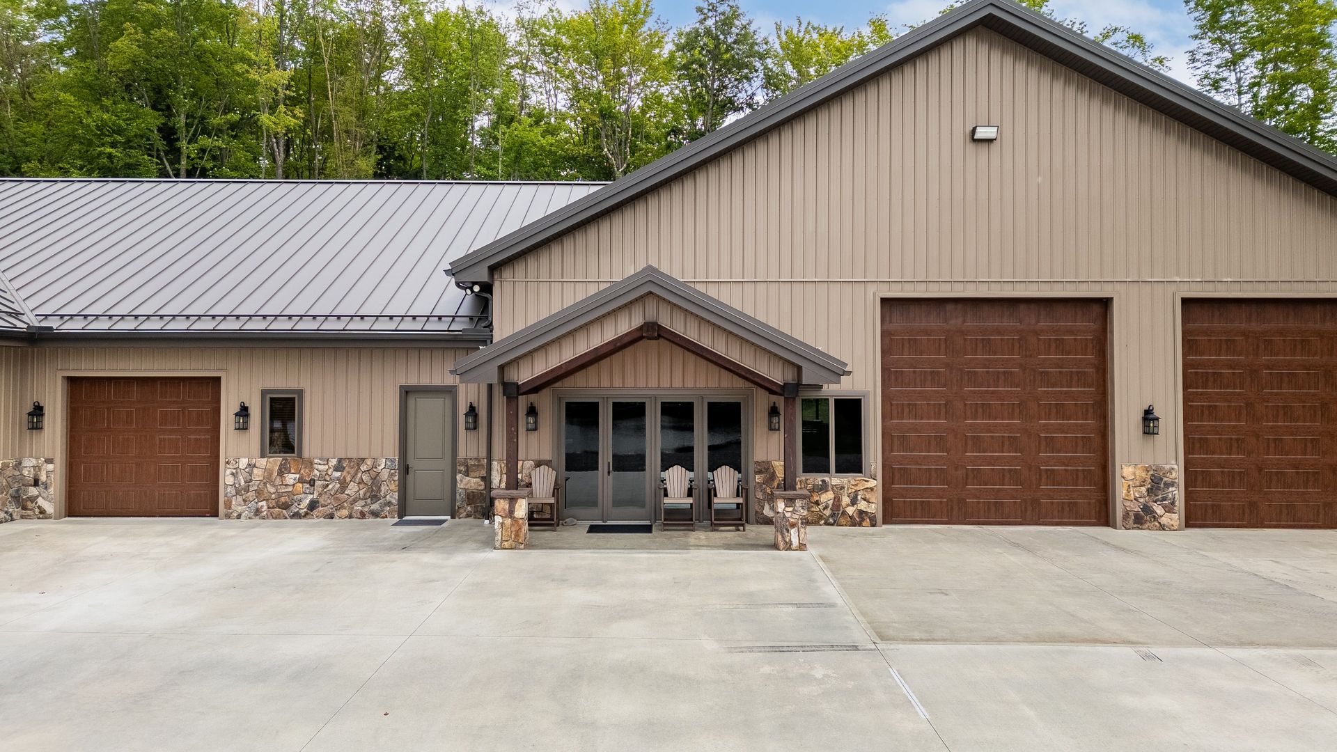 Entry view of Dellulo Garage featuring brown doors and metal roof, State College.