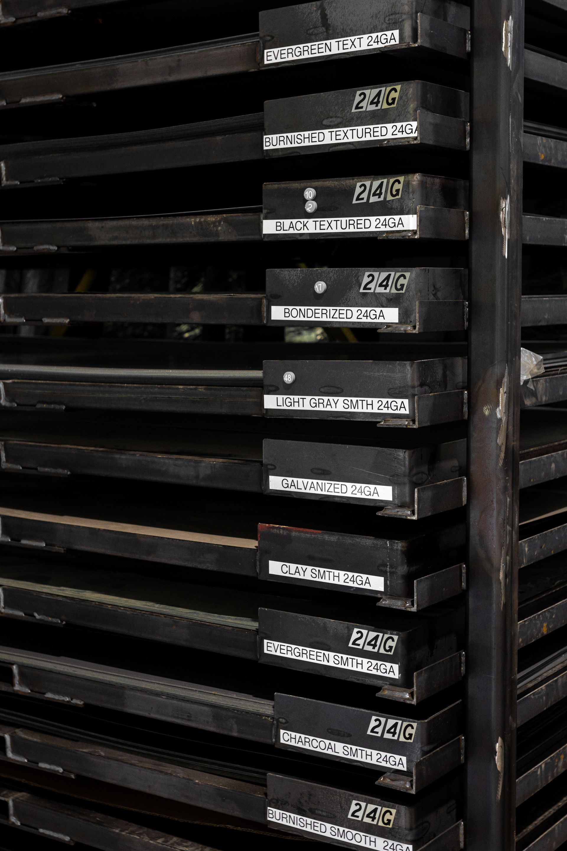 Black shelves stacked with labeled black boxes.