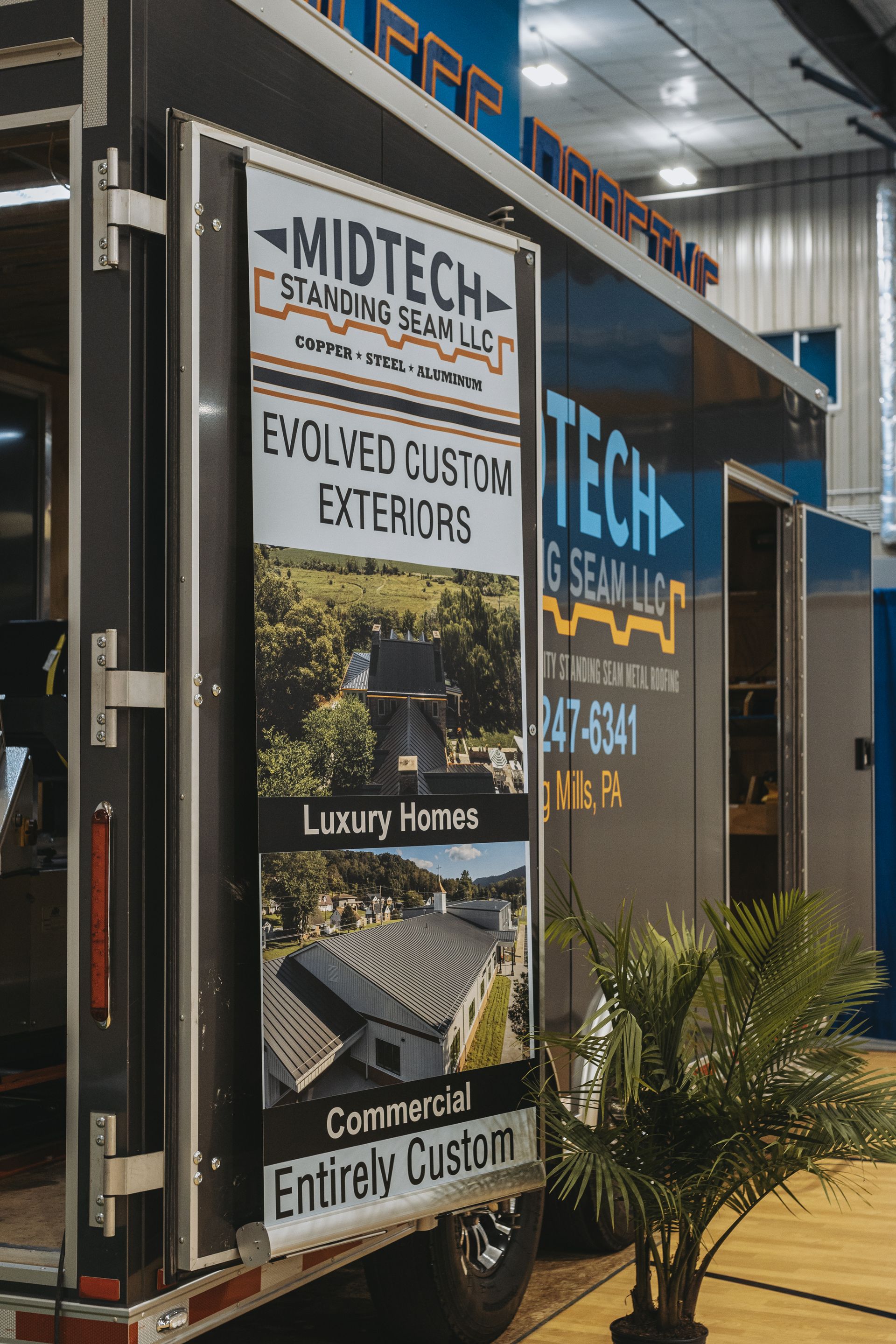 Sign on a trailer for Midtech Standing Seam LLC, featuring custom exterior photos.