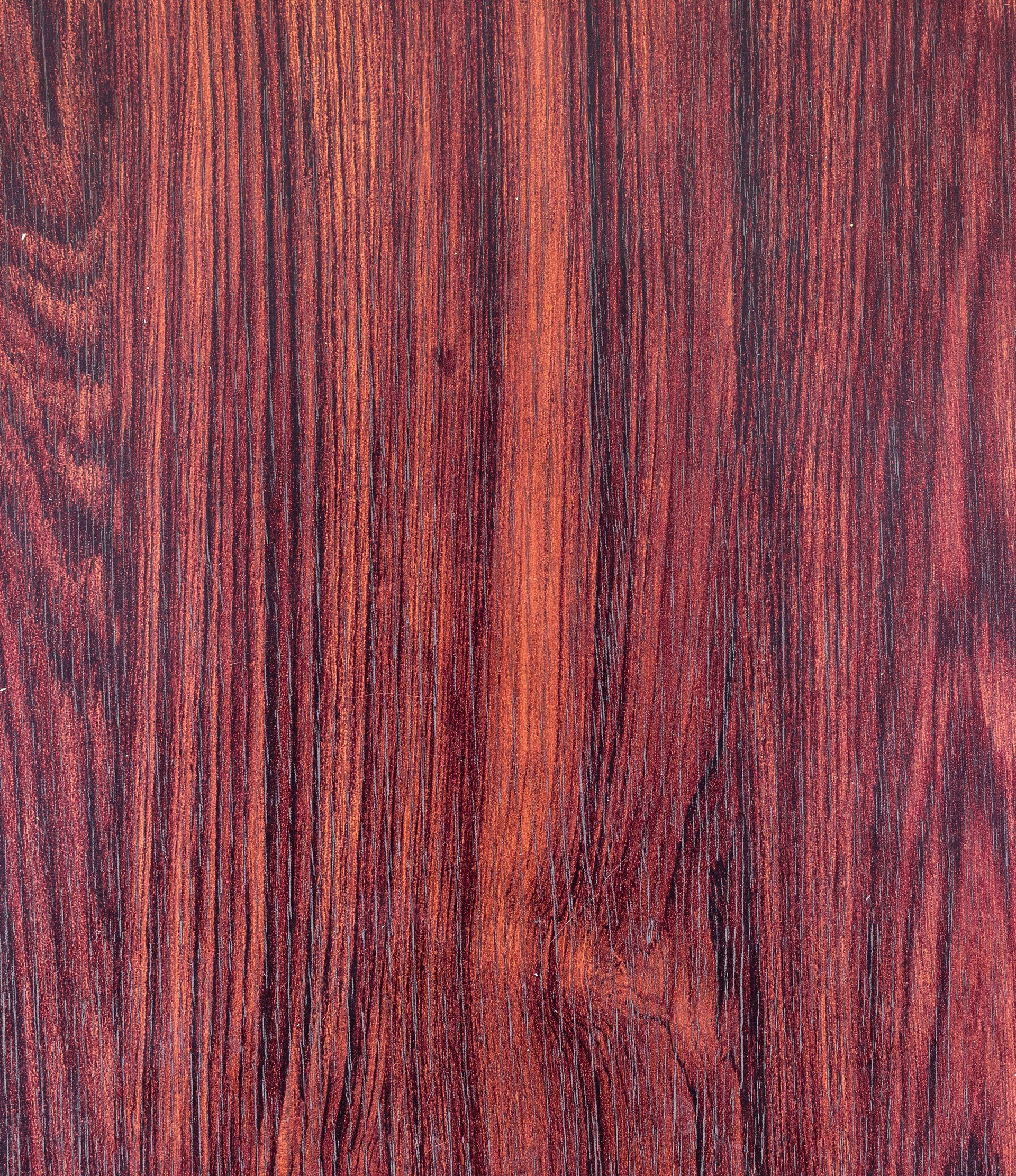 Dark red wood grain texture with vertical lines and variations in tone.