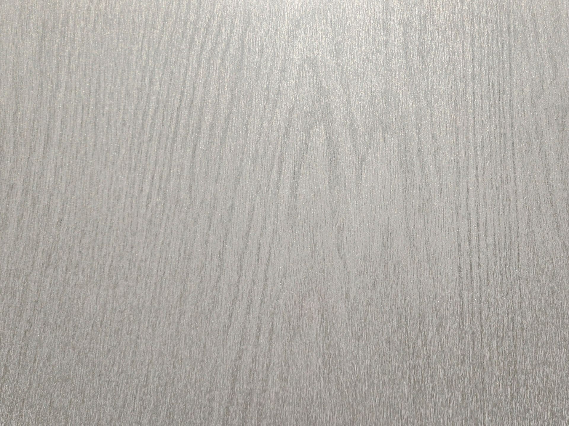 Textured grey surface with subtle vertical lines.
